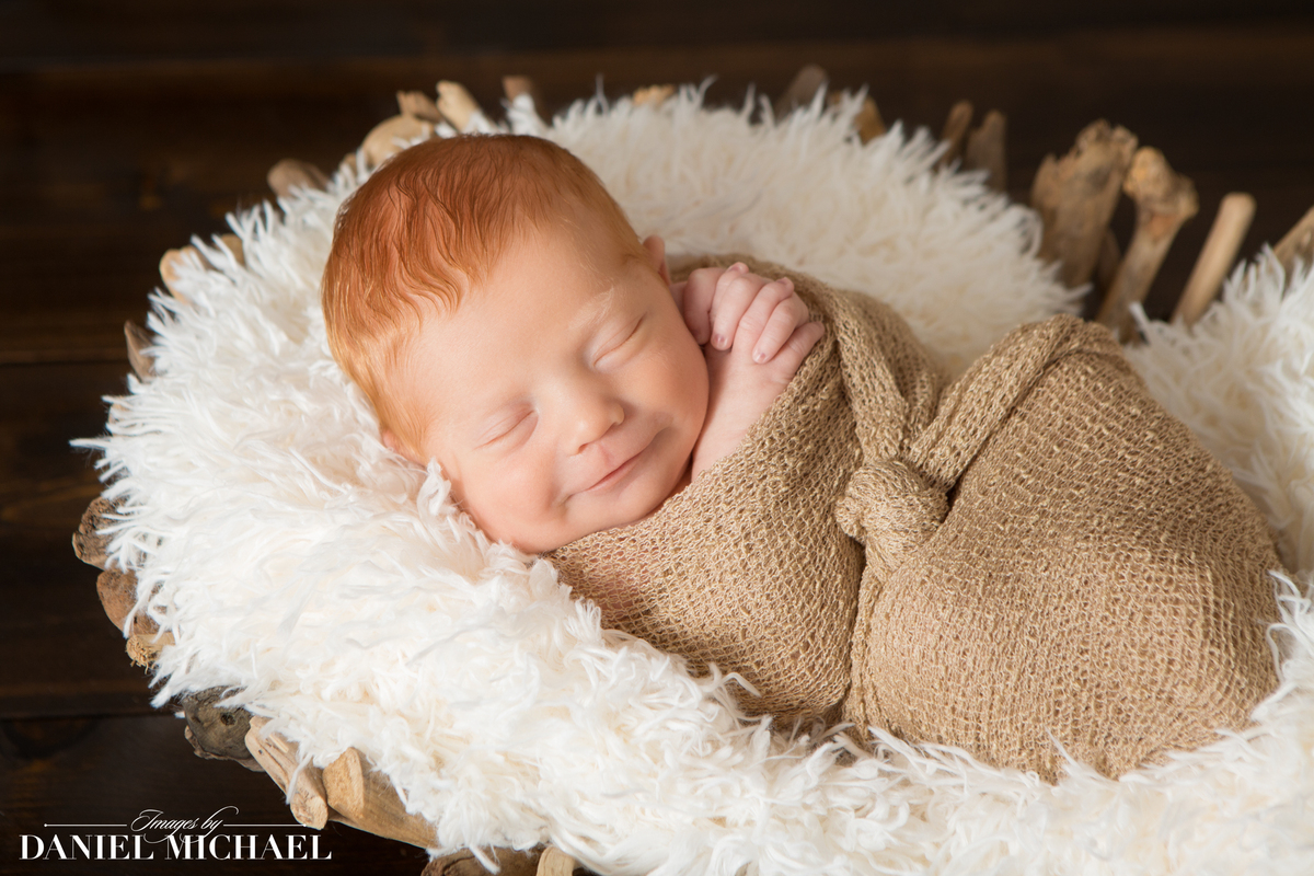 Baby smiling wrapped in cloth